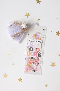 a bookmark with stars on it and a tassel hanging from the back,