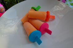 three plastic carrots sitting on top of a white plate