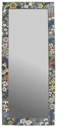 a mirror that is sitting on top of a wooden frame with flowers and leaves around it