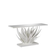 a white table with an artistic design on it's top and bottom shelf in the shape of a plant