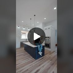 a man sitting on top of a kitchen counter