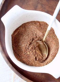 a bowl filled with brown powder and a spoon