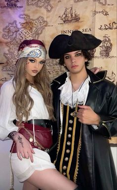 two people dressed in pirate costumes posing for the camera