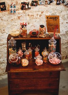 a wooden table topped with lots of candy