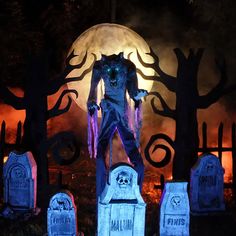 a creepy man standing in front of tombstones at night