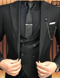 A three-piece suit typically consists of a jacket, trousers, and a waistcoat (vest). Here's a breakdown of each component: Jacket: The suit jacket is tailored to fit the body, often featuring a notched or peaked lapel, and can come with a single or double-breasted front. It usually has two or three buttons and may include pockets with flaps, a ticket pocket, and sometimes a subtle pattern or texture. Trousers: The trousers are designed to complement the jacket, often featuring a flat front or pl Groom Tuxedo Wedding, Tie Chain, Tuxedo Wedding Suit, Black Suit Men, Slim Fit Suit Men, Suits Men Business, Mode Costume, Groom Tuxedo, Dress Suits For Men