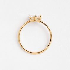 a yellow gold ring with two diamonds on top