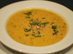 a white bowl filled with soup on top of a table