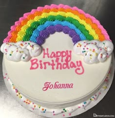 a birthday cake with rainbow frosting on it