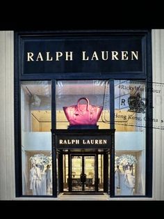 a store front with a pink handbag in it's display window and the words, ralphlauren