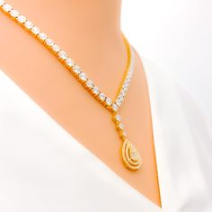 Presenting a sophisticated 18k yellow gold set, weighing 30.3 grams. It boasts 3.3ct of diamonds, combining Round and Baguettes, graded at G-H color and VS clarity. The necklace, with a length of 20" and a 1.25" drop, is secured by a lobster lock and offers 2.25" adjustable links. Complemented by 1.3" matching earrings with screw backs, this set captures elegance effortlessly. PRODUCT DETAILS Gold Purity(karat): 18k Item Weight(grams): 30.3 Item Finish: Yellow Gold Stone: Diamond Diamond Weight( Luxury Gold Diamond Necklace For Celebration, Luxury Yellow Gold Diamond-shaped Necklace, Luxury Yellow Gold Drop Diamond Necklace, Luxury Dazzling Yellow Gold Necklace, Lock Style, Diamond Necklace Set, Drop Design, Vs Diamond, Yellow Gold Setting