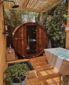 a hot tub sitting on top of a wooden deck next to a white bath tub