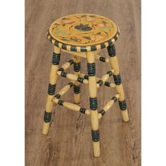 a stool made out of wooden sticks and painted with flowers on the seat is sitting on a wood floor