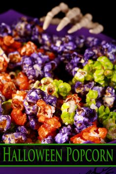 a purple bowl filled with halloween popcorn on top of a table