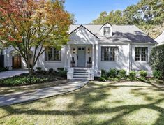 a white house with trees in the front yard