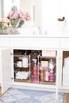 an organized bathroom cabinet with lots of items in it