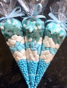 three blue and white candy sticks with bows on them