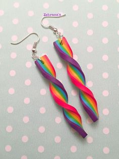 the earrings are made out of plastic and have rainbow colors