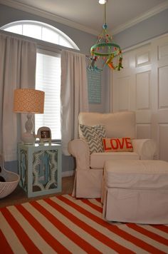 a living room filled with furniture and a lamp