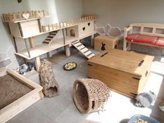 a living room filled with lots of furniture and cat beds on top of each other