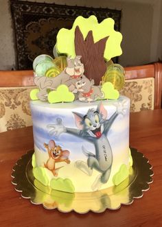 a cake with cartoon characters on it sitting on a table