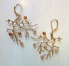 Carnelian Wild Branch Earrings, Bronze or Sterling Silver Organic branch earrings are hand-cast in golden bronze with secure 14k gold-filled lever-back ear wires. They are highlighted with 4mm Carnelian gemstone beads, like tiny berries. Wild and strong, yet delicate, and a bit of nature for your ears. They can also be cast in all sterling silver with sterling lever-back ear wires. The branch was cast in solid eco-friendly bronze using lost-wax casting. I start with a wax model, and then a plast Pendulum Earrings, Vintage Inspired Earrings, Branch Earrings, Plaster Molds, Celestial Jewelry, Geometric Triangle, Hand Cast, Recycled Sterling Silver, Gemstone Earrings