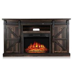 an entertainment center with a fire place and sliding doors on the front, in dark wood