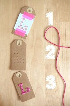 some crafting supplies are laid out on a wooden table with numbers and tags attached to them