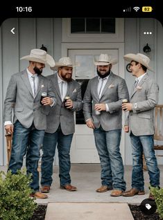 three men in suits and hats are standing on the porch with their hands in their pockets