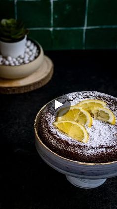 there is a cake with lemon slices on the top and powdered sugar on the bottom