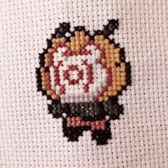 the cross stitch pattern has been made to look like an old computer game character