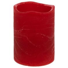 a red candle holder is shown on a white background, with the bottom half covered in wax