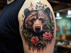 a man with a bear tattoo on his arm and shoulder, holding flowers in front of him