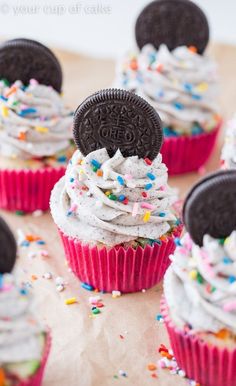 cupcakes with oreo cookies and sprinkles are on a table