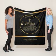 two women standing next to each other holding up a black and gold graduation banner that says graduation as a priest