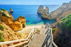 stairs leading down to the beach and ocean with cliffs in the background, cantaloupe beach, algares, portugal