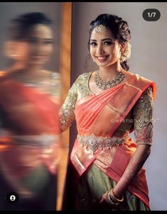 a woman in an orange and green sari