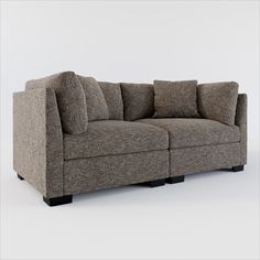 a gray couch with four pillows on it's back end and one arm facing the camera