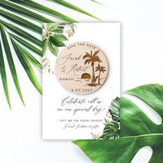 save the date magnets with palm trees and beach scene on them are shown next to a green leaf