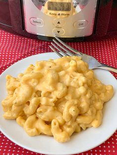 a plate of macaroni and cheese next to an instant pressure cooker