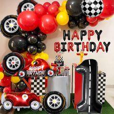 a birthday party with cars, balloons and streamers in the shape of race cars