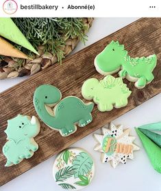 decorated cookies sitting on top of a wooden board