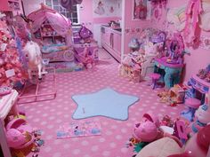 a pink room filled with lots of toys and decor on the walls, floor and ceiling