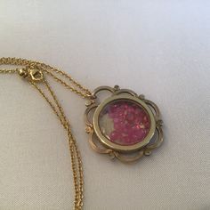 "Antique Art Nouveau Guilloche Locket filled with rubies. The gemstones move freely in the double-sided locket. The precious gems are gorgeous and beautiful quality. I meticulously search the world for the best quality and price. The gold-plated Guilloche round locket is from the early 1900's and a Gorgeous statement piece. It has a diameter of approx. 1 1/8\" and sparkles with rubies! It hangs from a 18\" gold-plate chain that extenders to 30\". It will come to you in a gift box. The Perfect gi Yellow Gold Brass Jewelry With Birthstone, Yellow Gold Birthstone Brass Jewelry, Yellow Gold Birthstone Jewelry In Brass, Unique Yellow Gold Birthstone Jewelry, Unique Yellow Gold Jewelry With Birthstone, Antique Gold Keepsake Pendant Jewelry, Antique Gold Pendant Jewelry For Keepsake, Yellow Gold Medallion Jewelry With Birthstone, Victorian Necklace With Detachable Pendant For Gift