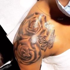 a close up of a woman's arm with flowers on it