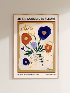 a painting hanging on the wall with flowers in it's center and an inscription that reads je tauquiles des fleururs