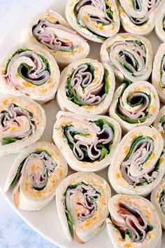 a white plate topped with rolls covered in veggies