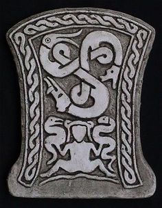 a silver buckle with an ornate design on it