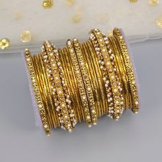 Set of 26 pcs gold plated metal Bangles. Studded with stones and pearls. Bangle Set Gold, Metal Bangles, Star Bangle, Indian Bangles, The Bangles, Bangles Indian, Bangle Set, Jewellery Gift, Indian Jewellery