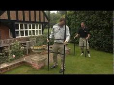 two men are standing in the yard with their canes